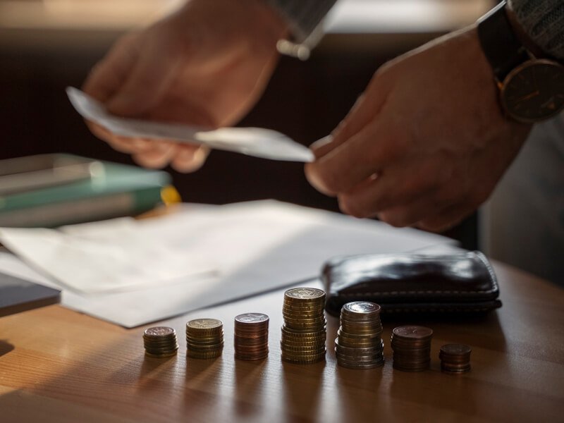 Close up on coins saved for energy crisis expenses