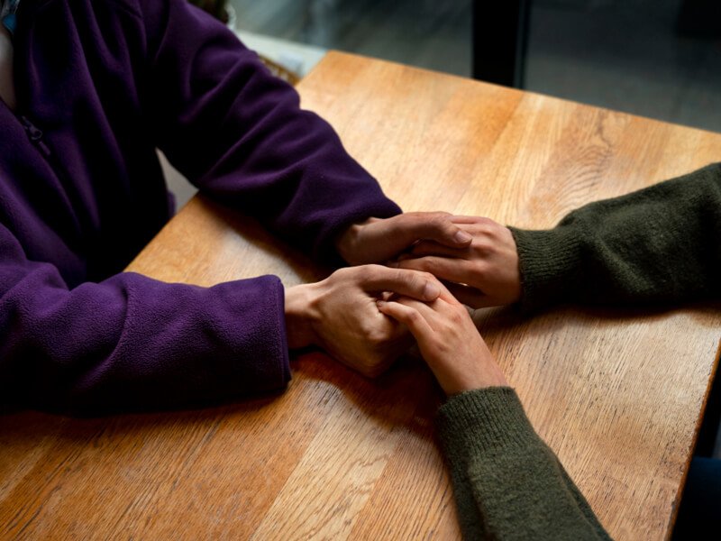 Hands holding each other for support